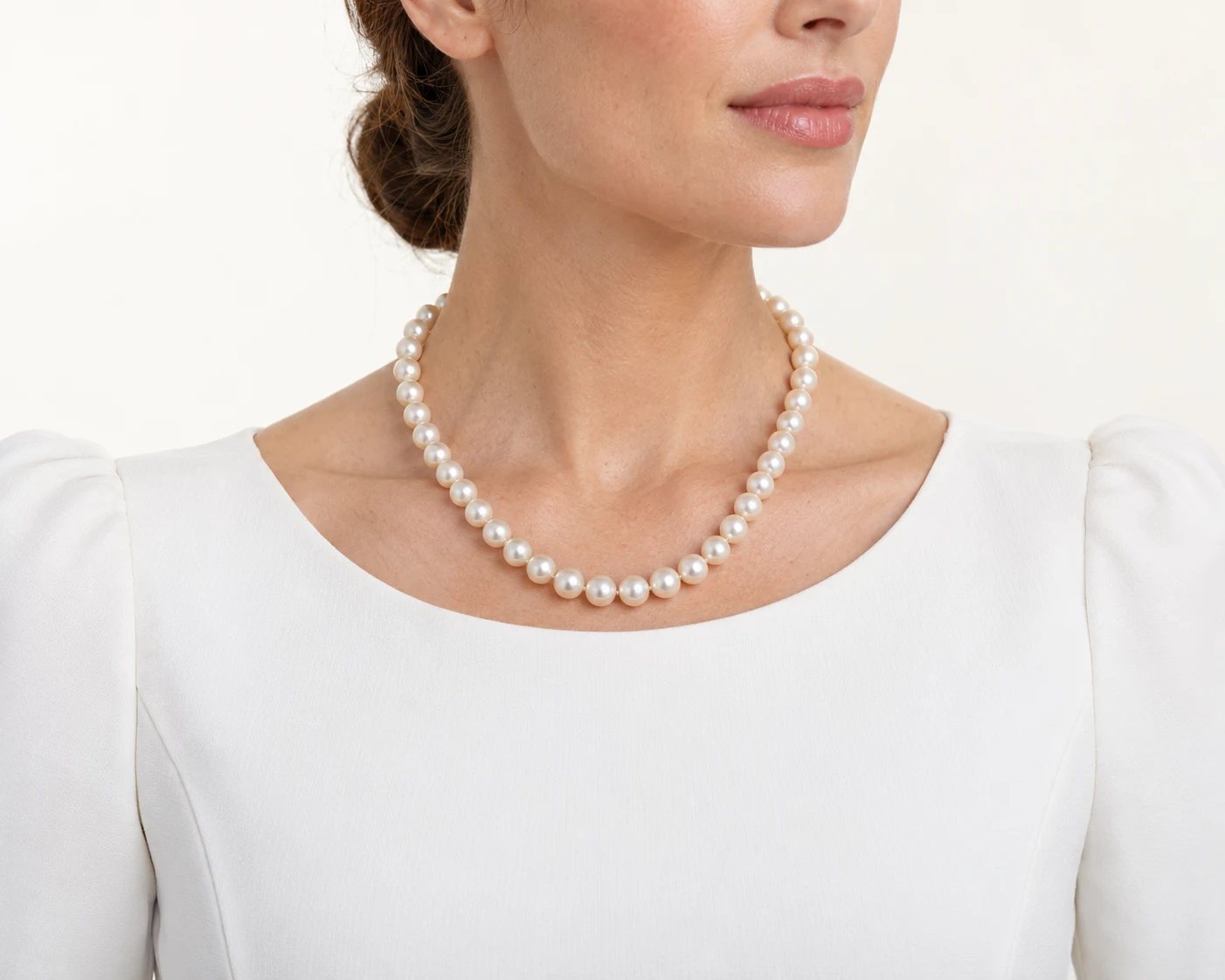 Approximately 8mm pearls in a single strand on the same model for visual comparison