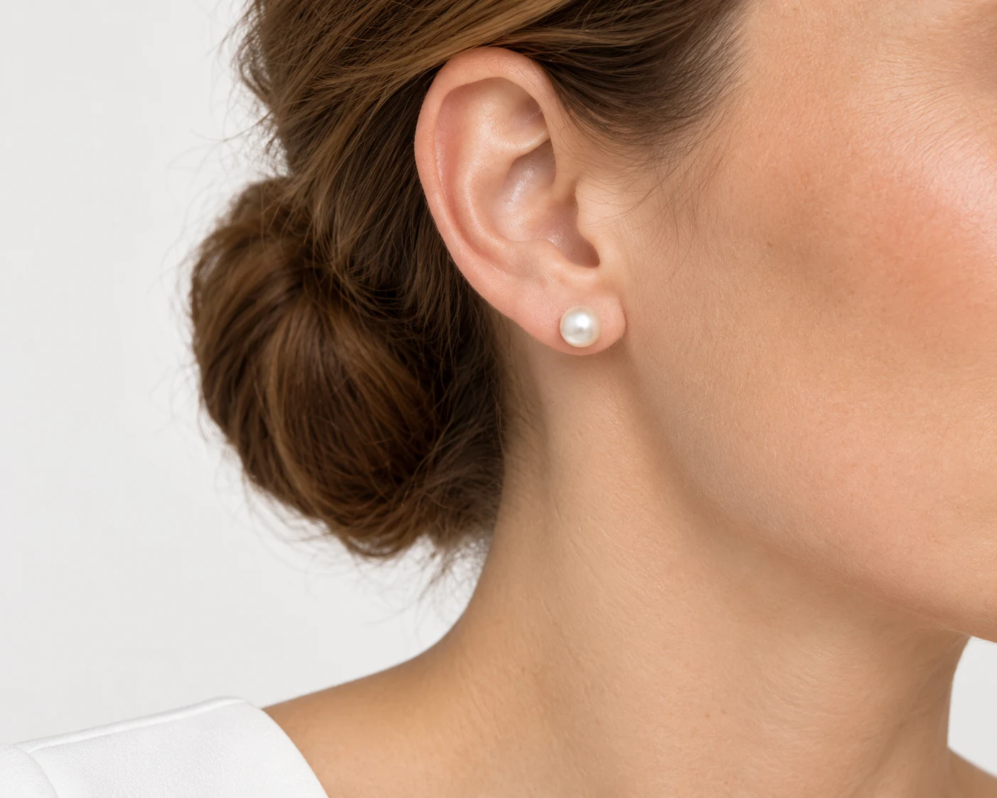 Approximately 8mm pearl stud on the same side-profile model for visual comparison